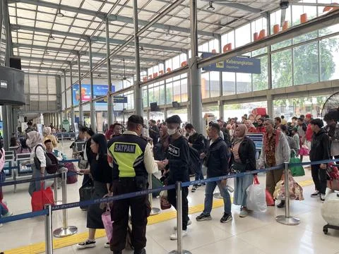 Train passengers queue to enter the train departure waiting room Stock Photos