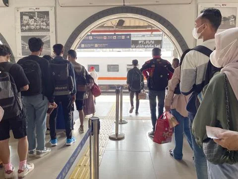 Train passengers queue to enter the train departure waiting room Stock Photos