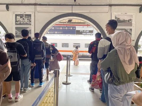 Train passengers queue to enter the train departure waiting room Stock Photos