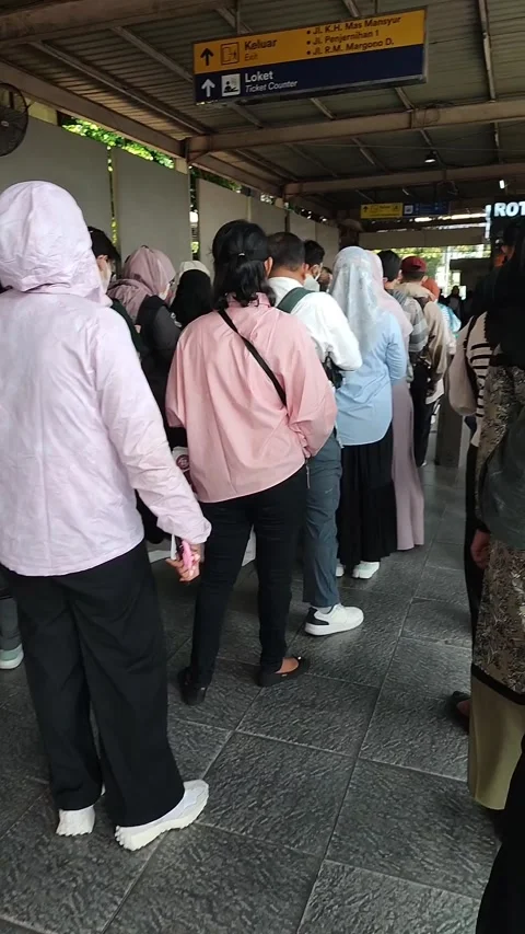 Train passengers queue at the exit platform of Jakarta Karet Station Stock Footage 287530271
