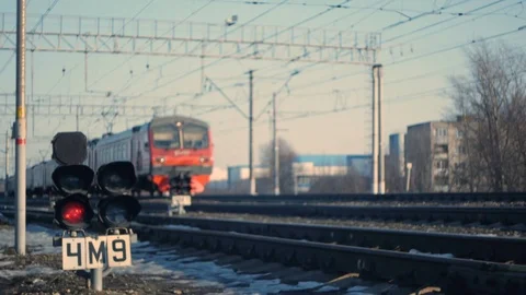 The train passes against the background of a red traffic light, from shadow to l Stock Footage 125136918