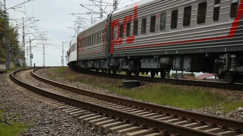 The train passes on the background of the sea and goes around the bend Stock-Footage 114571409