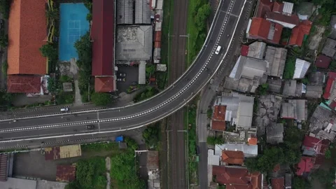 Train Passes Between Flyover and Residential Area in Bogor, Feb 24 2024 Stock Footage 280175380