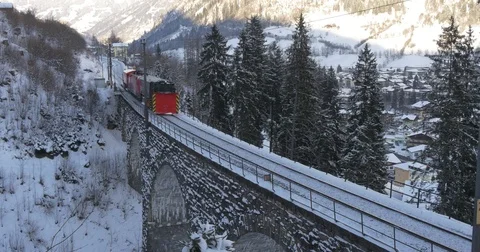Train passes the bridge in the mountains Stock Footage 82744149