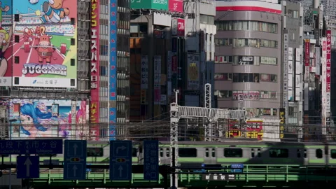 Train Passes Bright Large Signs In Japanese Landscape Tokyo Stock Footage 239753935