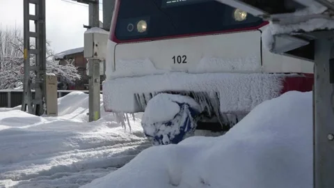A train passes the camera in a snowy landscape Stock Footage 231550009