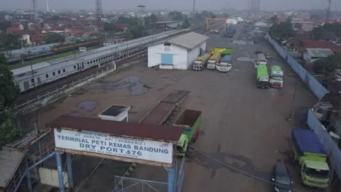 The train passes in the container area Stock Footage 236984554