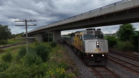 Via train passes Eastbound under bridge Cobourg On Canda on August 11, 2024 Stock Footage 284112034