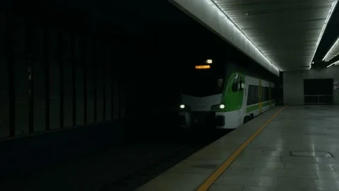 A train passes by an empty railway station platform. Stock Footage 220106138