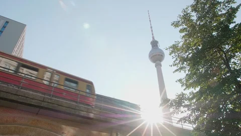 A train passes in front of the TV tower in Alexanderplatz, Berlin Stock Footage 102845860