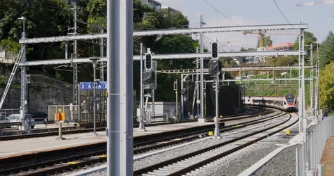 Train passes at great speed and arrives at the station. Commuter train from S Stock Footage 116730036