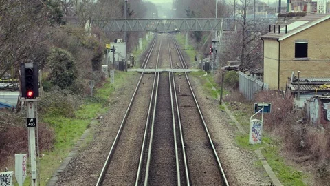 A Train passes a Level crossing in London Stock Footage 103169657