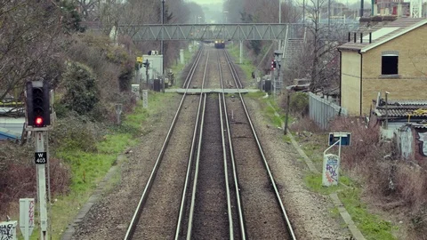 A Train passes a Level crossing in London Stock Footage 103169735