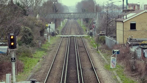 A Train passes a Level crossing in London Stock Footage 103169937