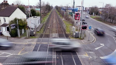 A Train passes a Level crossing in London Stock Footage 103169979