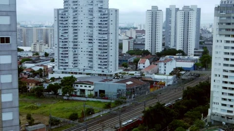 Train passes next to residential High Rise Buildings in Sao Paulo, Brazil Stock Footage 265198674