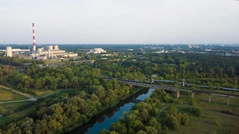 Train Passes the Overpass Across the Warta River. Aerial View Stock Footage 332058054
