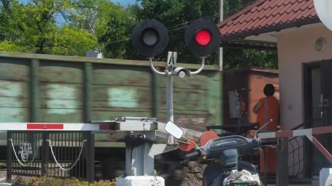 The train passes through the crossing Stock Photos