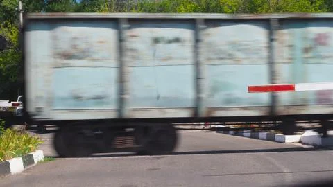 The train passes through the crossing Stock Photos