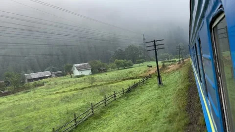 The train passes through a mountain valley in the morning Video stock 250837778