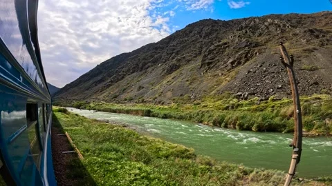 The train passes through a mountainous landscape Stock Footage 282362885