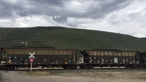 Train passes through railroad crossing HD Stock Footage 80235845