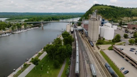 A train passes through the town Red Wing, Minnesota along the Mississippi River Video stock 281207798