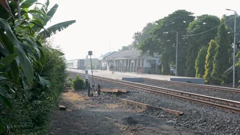 A train passes through an urban road, Bandung, West Java, Indonesia. Stock-Footage 252544207