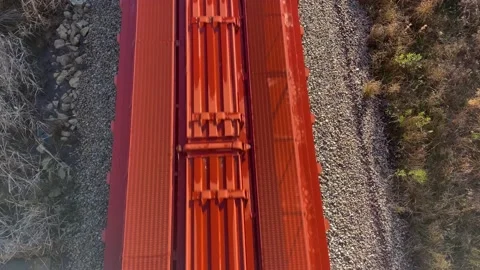 A train passes under a bridge on a bright morning in Georgia Pan up with soun Stock Footage 147096793