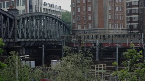 Train passes under iron bridge - urban London, UK Stock Footage 93209986