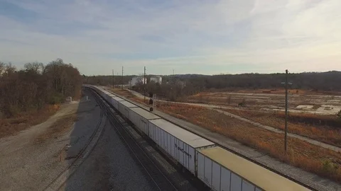 Train passes underneath and goes into distance. Drone shot. High angle. Stock Footage 85178755