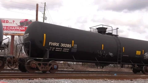 A train passes by in an urban area on a cloudy day Stock Footage 143438813
