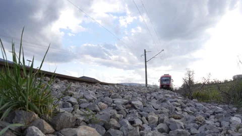 A Train passing by and rocks in the foreground Stock-Footage 240791807