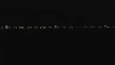 Train Passing Behind Truss Bridge At Night - Japan Stock Footage 345170798