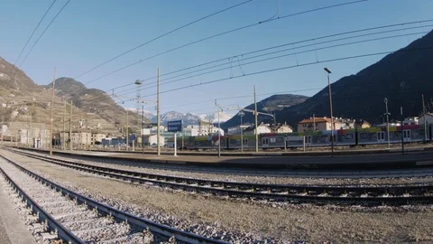 Train passing by in Bolzano train station with mountains background. Trentino 스톡 동영상 112717067