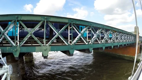 Train passing on a bridge above River Thames in London Stock Footage 80065493