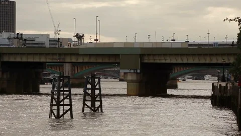 Train passing on bridge in the evening, London Video stock 76384998