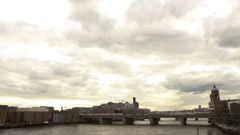 Train passing on bridge with sky cloudy, London Stock Footage 76385044