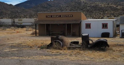 Train passing building in desert Stock Footage 87635396