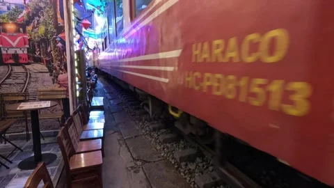 A train passing closely through the famous Hanoi Train Street cafe, Vietnam. Stock Footage 335796065