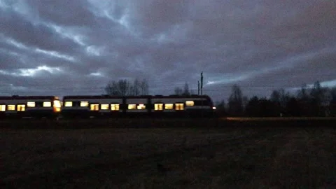 Train passing by at dusk Stock Footage 235854160