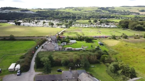 Train passing a farmers field. Stock Footage 249094420