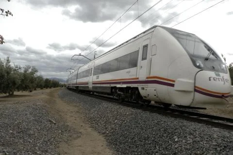 Train passing at half speed on a road Stock Photos