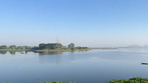 The train is passing by a large lake. Video stock 323355166