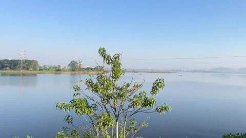 The train is passing by a large lake. Stock Footage 323355198