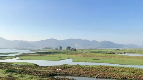 The train is passing by a large lake. Stock Footage 323355678