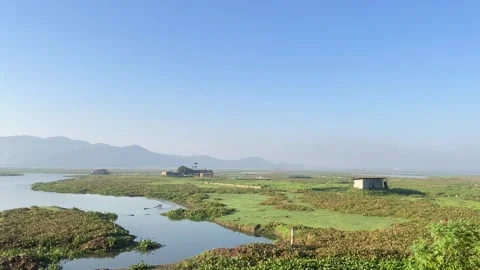 The train is passing by a large lake. Stock Footage 323355786