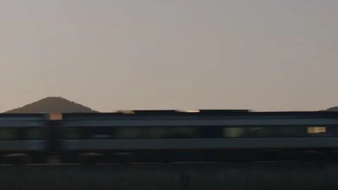 Train passing by Mountain Countyside Sunset view Stock Footage 201699313