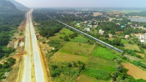 Train passing near under work road background green mountain and tree Foto stock