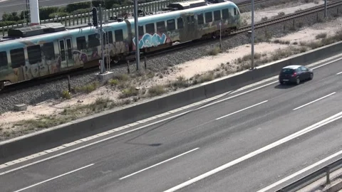 The train is passing next to the highway Stock Footage 146998948